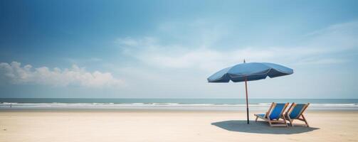 Summer Chairs and umbrellas on tropical sea and beach with blue sky background. photo