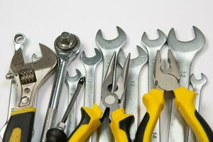 Set of tools for repair in a case on a white background. Assorted work or construction tools. Wrenches, Pliers, screwdriver. Top view photo