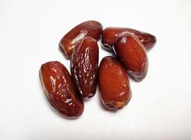 Close up of dried dates fruit isolated on white background photo
