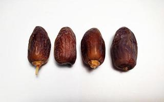 Close up of dried dates fruit isolated on white background photo