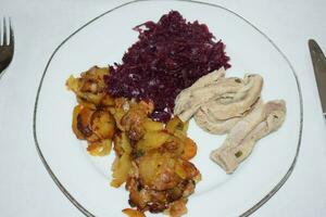 Sliced Cooked Bacon with Red Cabbage and Fried Potatoes photo