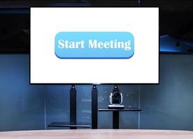 Television with blue button message Start Meeting on display in meeting room photo