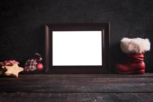Blank frame on wooden background photo