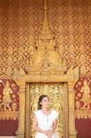 Young Asian Woman at Wat Sene Souk Haram ,Luang Prabang, LAOS photo