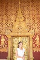 Young Asian Woman at Wat Sene Souk Haram ,Luang Prabang, LAOS photo