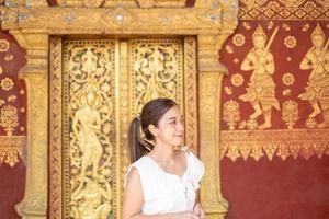 Young Asian Woman at Wat Sene Souk Haram ,Luang Prabang, LAOS photo