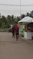 Gorontalo, March 2023 - Marathon running race, people feet on city road. Running people at a Marathon competition photo