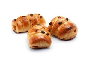 a group of buns with raisin toppings isolated on solid white background. photo