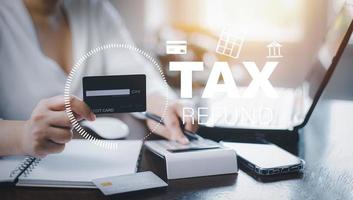 Concept credit card with tax payment optimization business finance, woman using a calculator and tax payment calculation, income tax, individuals and corporations such as VAT, annual income tax photo