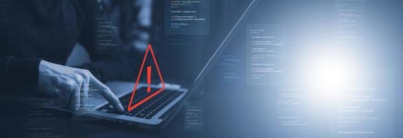 notification error and maintenance with triangle caution warning sign for notification error, Programmer using laptop with triangle caution warning sign, hacker attacks , cyber crime, cyber security photo