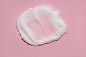 White lather foam moisturizer cleanser on pink photo