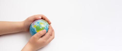 Environment for future, save the planet concept. World globe in child hands top view with copy space photo