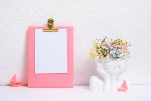 Message board mockup with creative plaster head vase with flowers. Mind care concept photo