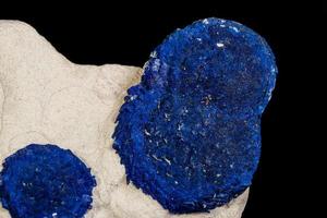 Macro mineral stone Azurite in siltstone against black background photo