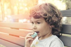 Child eating marshmallow photo