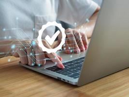 Businessman working with laptop computer showing Symbol of the leading service ISO Certification Document Management System, product standard auditing. Quality Control Standards photo