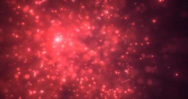 Abstract red energy particles and dots glowing flying sparks festive with bokeh effect and blur background photo