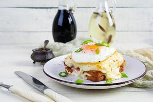 Delicious breakfast. Hot french toast with ham and bechamel sauce - croque madame photo