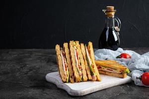 Club sandwich with ham, tomato, green and cheese. Grilled panini photo