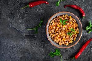 Chili con carne in a bowl. Mexican cuisine. Chili with meat, corn and beans photo