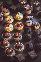 Mini cakes on wooden background photo