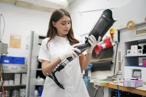 Orthopedic technician making prosthetic leg for disabilities people in workshop. photo