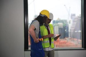 Architect, foreman working at construction or architecture site photo