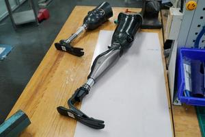 Orthopedic technician making prosthetic leg for disabilities people in workshop. photo