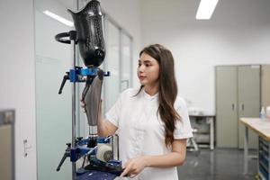 Orthopedic technician making prosthetic leg for disabilities people in workshop. photo