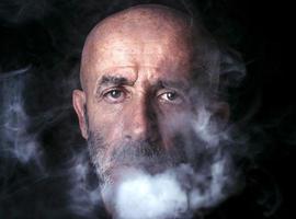 Man blowing smoke photo