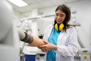 Orthopedic technician making prosthetic leg for disabilities people in workshop. photo