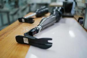 Orthopedic technician making prosthetic leg for disabilities people in workshop. photo