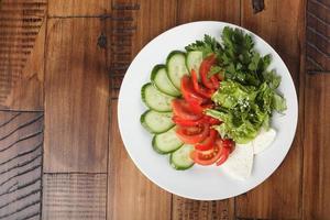 vegetable mix salad, cucumber, tomato, parsley and cheese photo