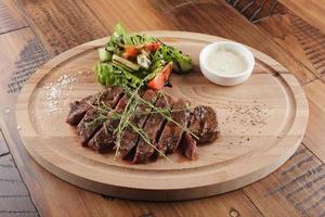 Top blade steak with salad and sauce photo