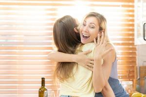 Happy LGBTQ lesbian smiling showing couple wedding rings happiness with love together. Cheerful Homosexual couple embracing. LGBTQ Pride Month. photo