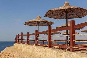 sunshade beach umbrellas in resort in Sharm El Sheikh, Egypt photo