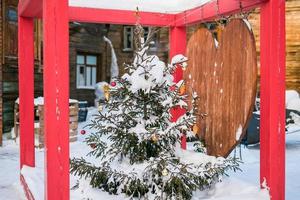 Close up decorated christmas tree balls bauble and New Year's garlands on outside in town square - xmas and winter holidays in cityscape photo