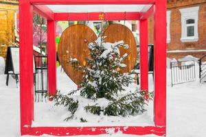 Decorated christmas tree balls bauble garland and New Year's garlands on outside in town square - xmas and winter holidays in cityscape photo