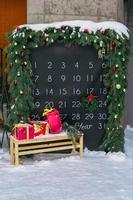 Simple desk advent calendar for December 2022 in city park with Christmas decorations photo