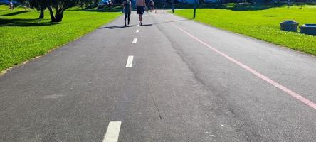outdoor park with running track and people doing physical activity photo