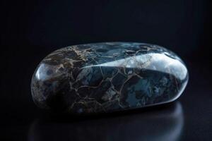 Musgravite is a rare precious natural geological stone on a black background in low key. . photo