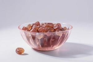 date seeds in a bowl on a white surface, in the style of translucent geometries, graceful poses, infused with social commentary, generat ai photo