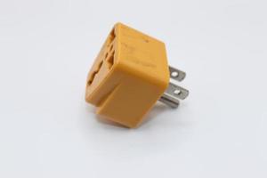 Isolated Yellow multi plug adapter on white background photo