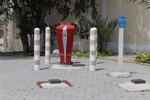 Fire hydrant placed in the garden with barrier for safety photo