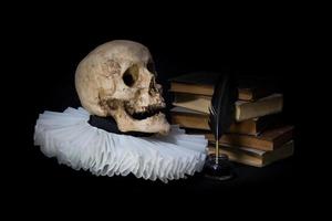 Books with a quill, inkwell, skull and ruff. world literature concept photo