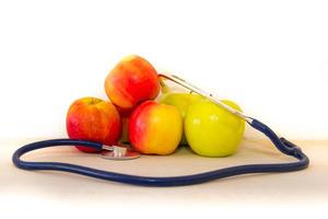 health concept with green and red apples and stethoscope photo