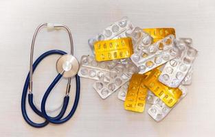 health concept with stethoscope and empty packs of pills photo