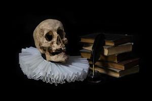 Books with a quill, inkwell, skull and ruff. world literature concept photo
