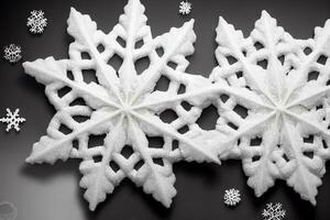 couple of snowflakes sitting on top of a table. . photo