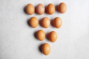 Fresh chicken eggs on white concrete floor background. The benefits of eating eggs are high protein. Copy Space photo